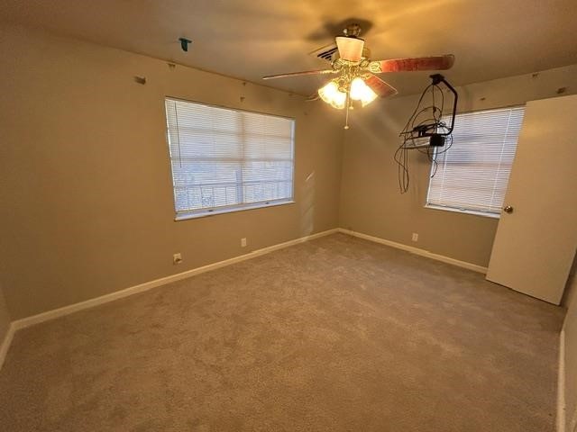 4420 Raven Street Beaumont, TX 77705 - Photo 7 of 11 en empty room with windows and fan