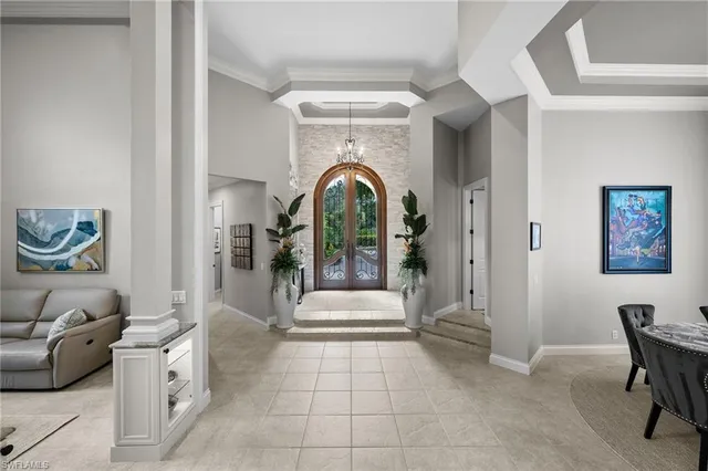 a living room with furniture and a entryway