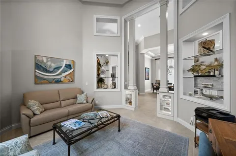 a living room with furniture a rug and wall painting