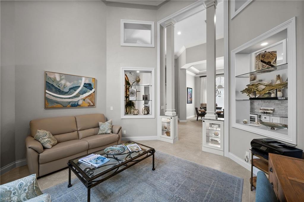 23841 Addison Pl Court Bonita Springs, FL 34134 - Photo 24 of 47 a living room with furniture a rug and wall painting