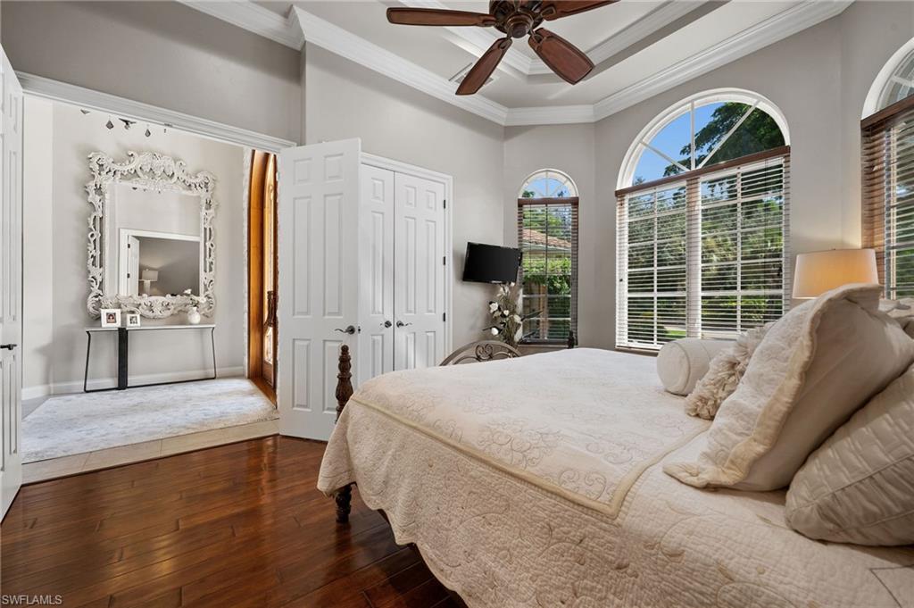 23841 Addison Pl Court Bonita Springs, FL 34134 - Photo 25 of 47 a bedroom with a bed large window with wooden floor