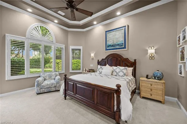 a spacious bedroom with a bed and a chandelier