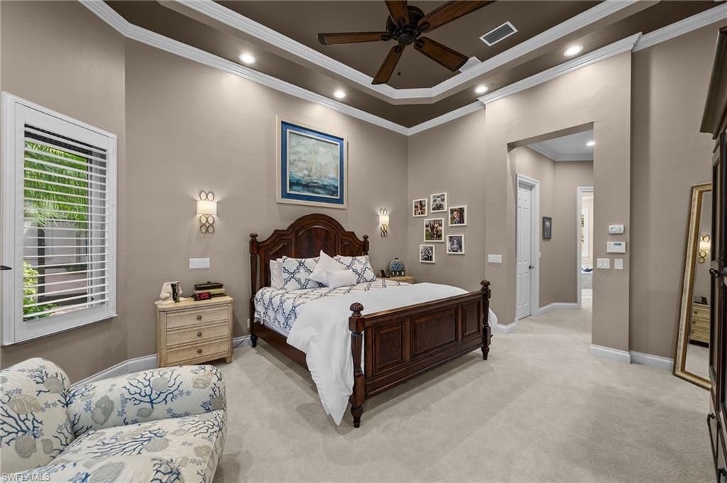 23841 Addison Pl Court Bonita Springs, FL 34134 - Photo 27 of 47 a bedroom with a large bed and a chandelier