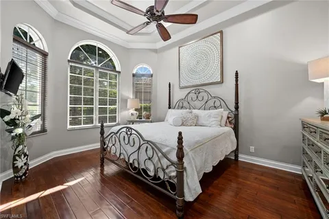 a bedroom with a bed mirror and window