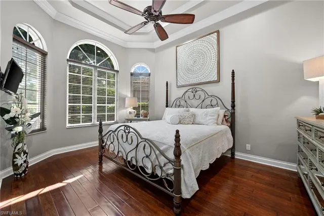 a bedroom with a bed mirror and window