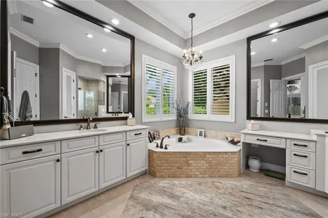 a large spacious bathroom with a large tub sink and mirror