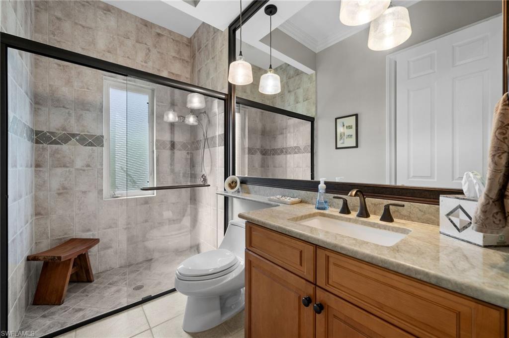 23841 Addison Pl Court Bonita Springs, FL 34134 - Photo 30 of 47 a bathroom with a granite countertop sink mirror vanity and toilet