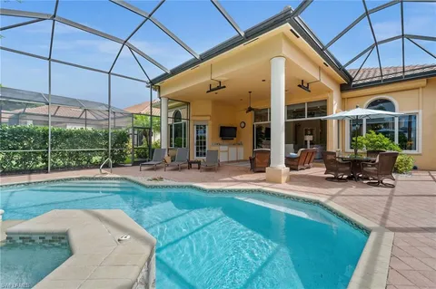 a view of a house with a backyard patio and swimming pool
