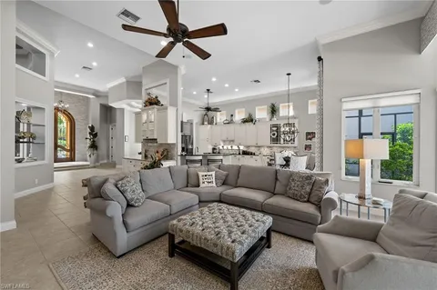 a living room with furniture and a view of kitchen