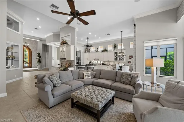 a living room with furniture and a view of kitchen