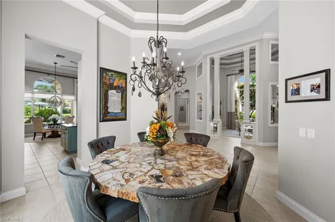 a view of a dining room with furniture and chandelier