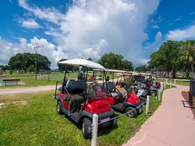a view of swimming pool with seating area and trees in the background