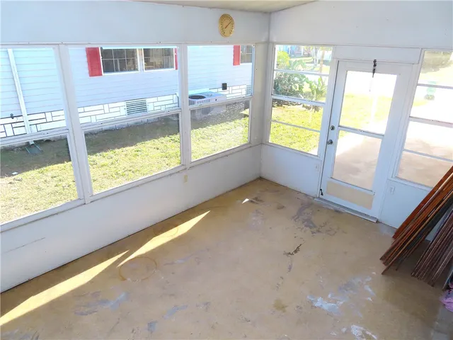 a view of an empty room and a window