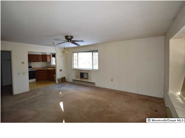 155D Sunset Road, Unit C Whiting, NJ 08759 - Photo 2 of 11 a living room with furniture and a flat screen tv