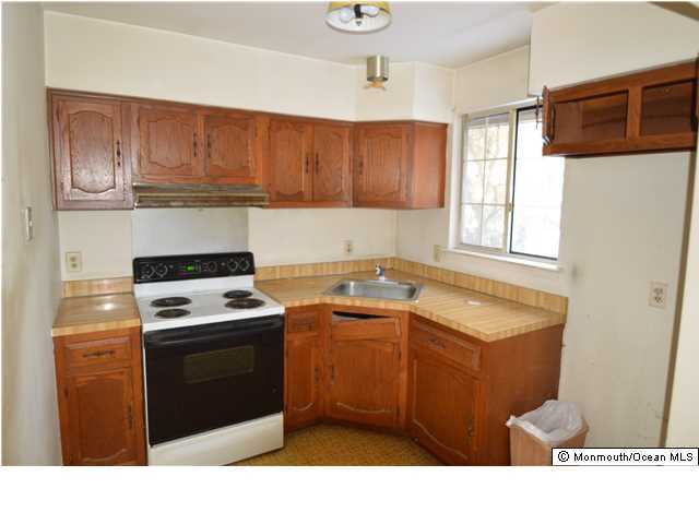 155D Sunset Road, Unit C Whiting, NJ 08759 - Photo 6 of 11 a kitchen with a stove cabinets and a window