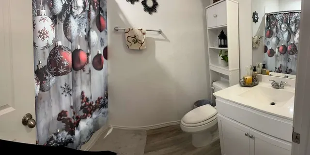 a bathroom with a toilet sink and mirror