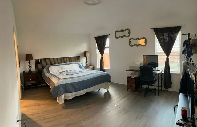 a bedroom with a bed and a chair