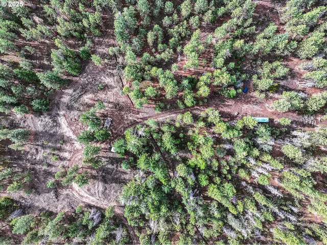 a view of dirt road with a building in the background