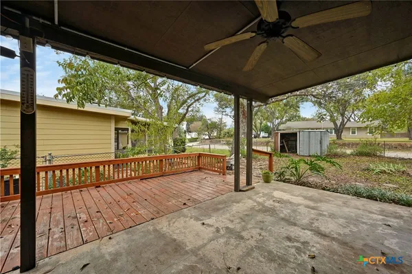 a view of a porch with wooden floor and roof
