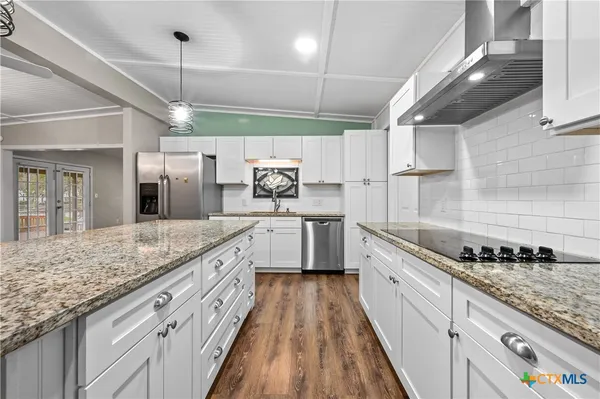 a large kitchen with a stove and cabinets