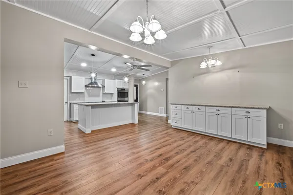a view of a kitchen with a dishwasher cabinets and wooden floor