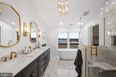 a en suite bathroom with a double vanity sink and a mirror