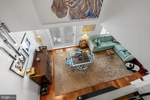 a kitchen with granite countertop a refrigerator stove top oven dining table and chairs