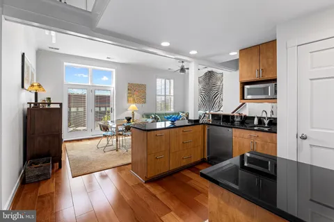 a dining room with furniture and wooden floor