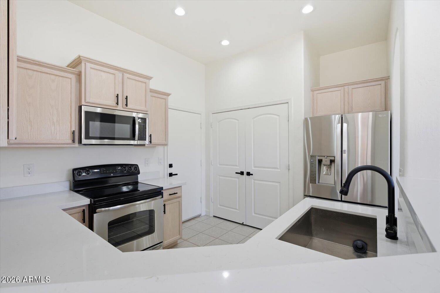 2565 South Signal Butte Road, Unit 23 Mesa, AZ 85209 - Photo 8 of 29 a kitchen with granite countertop a stove and a sink