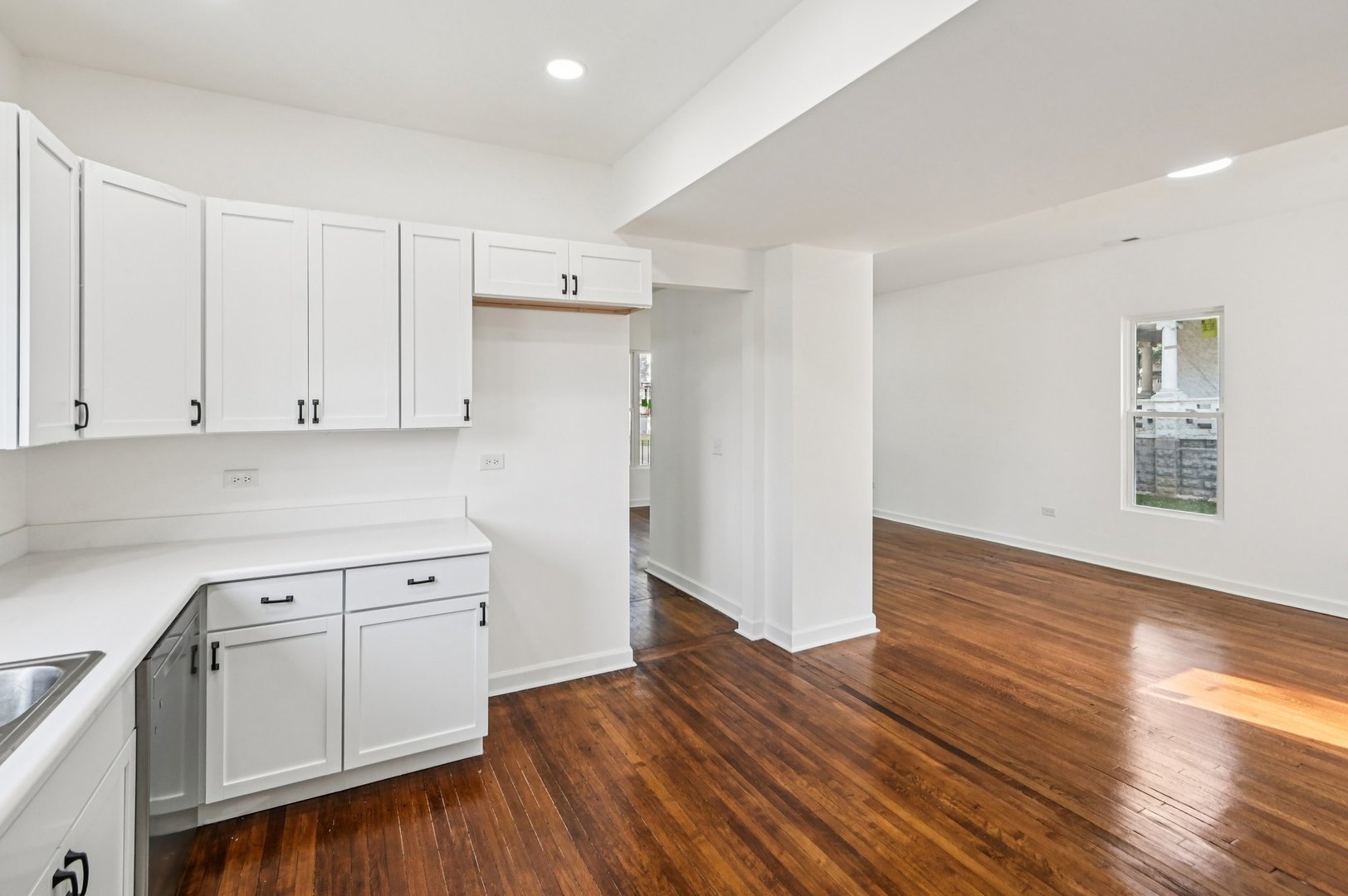 608 Whitley Avenue Joliet, IL 60433 - Photo 12 of 38 a kitchen with wooden floors and white cabinets