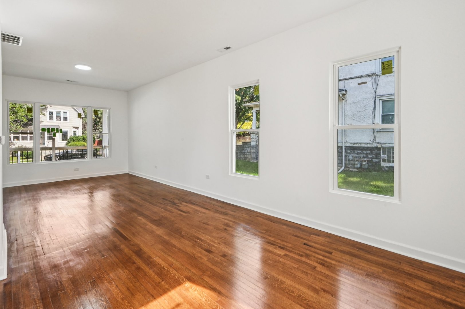 608 Whitley Avenue Joliet, IL 60433 - Photo 15 of 38 wooden floor in an empty room with a window