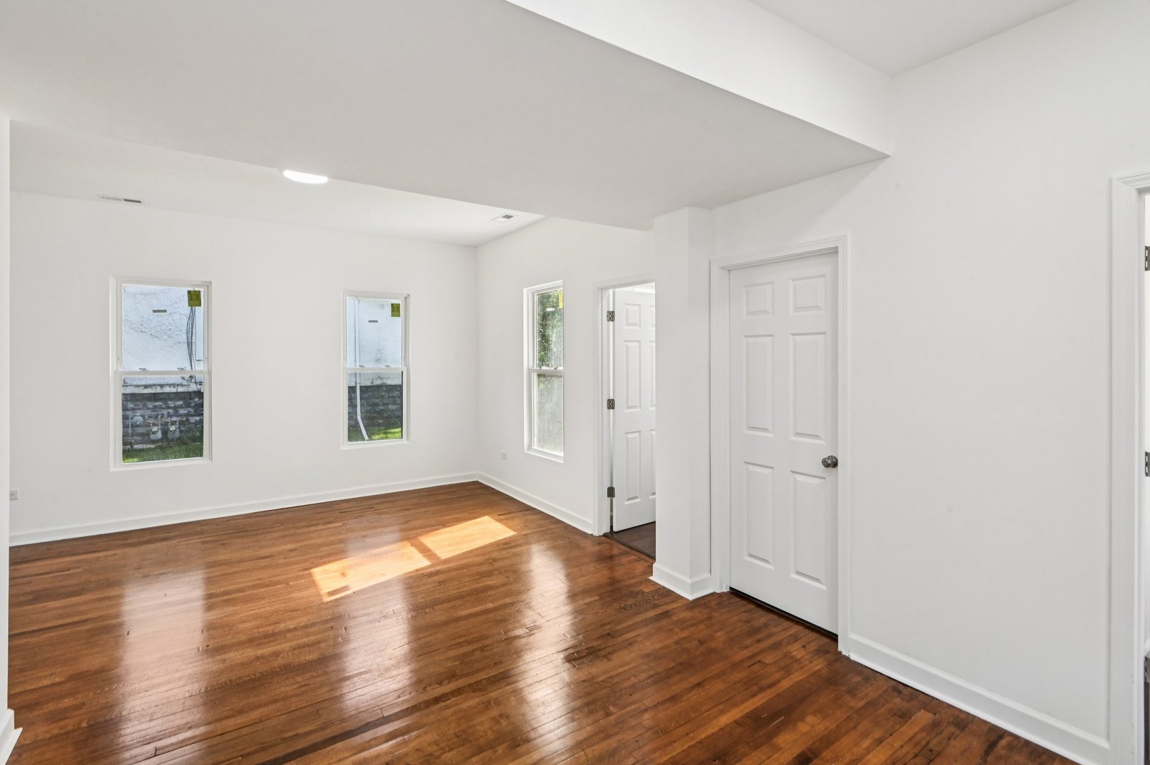 608 Whitley Avenue Joliet, IL 60433 - Photo 16 of 38 an empty room with wooden floor and windows