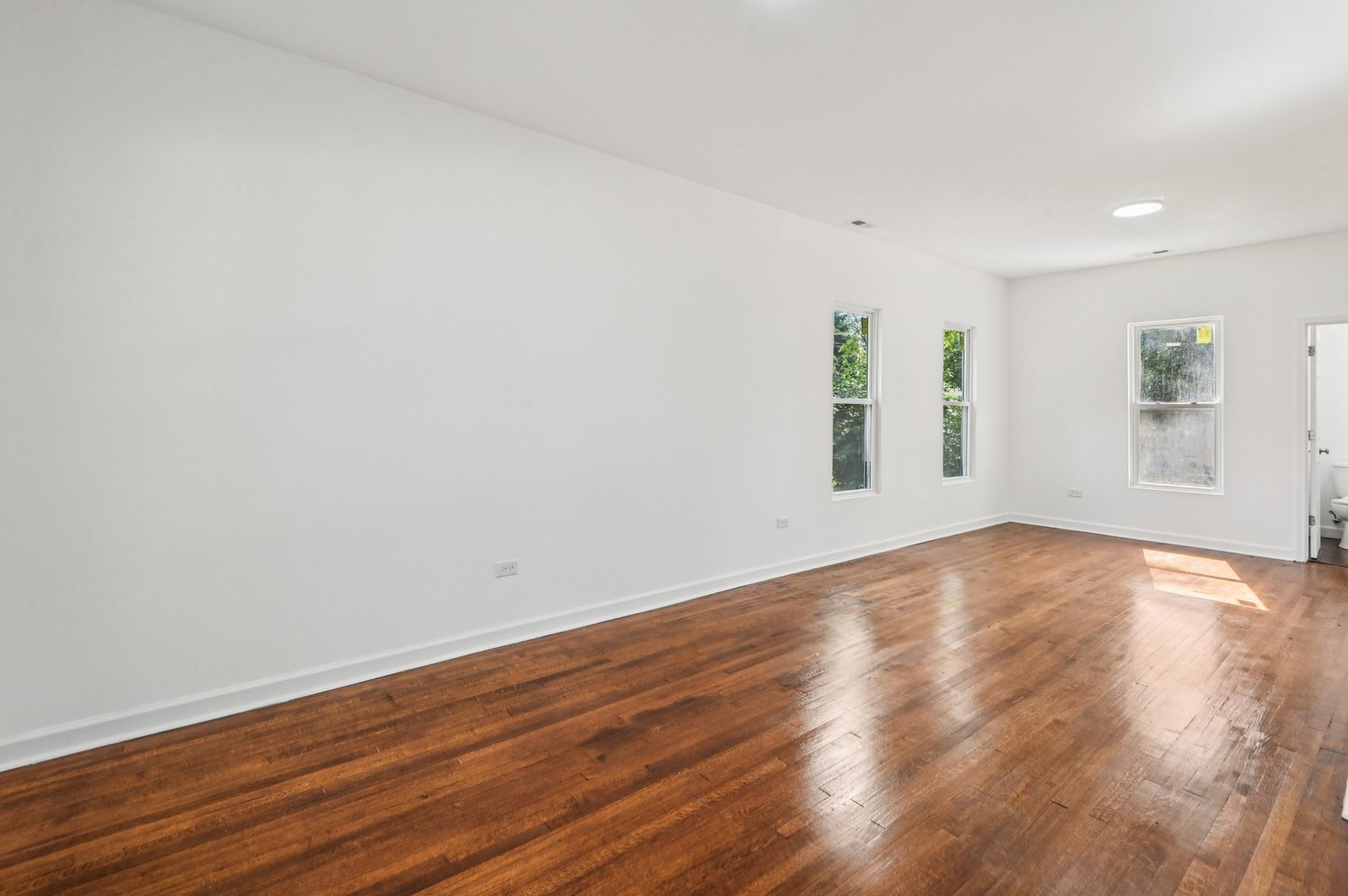 608 Whitley Avenue Joliet, IL 60433 - Photo 17 of 38 a view of empty room with wooden floor and fan