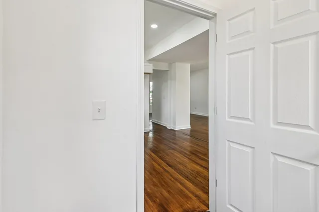 a view of a hallway with wooden floor