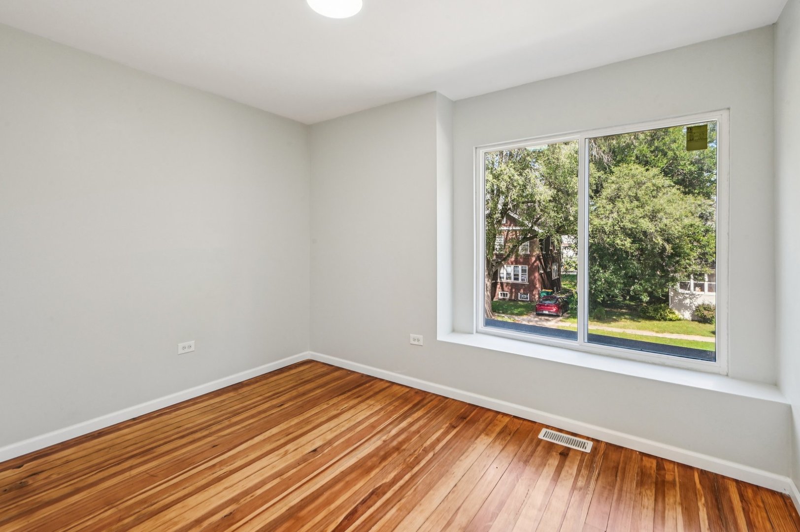 608 Whitley Avenue Joliet, IL 60433 - Photo 21 of 38 a view of a room with wooden floor and a window