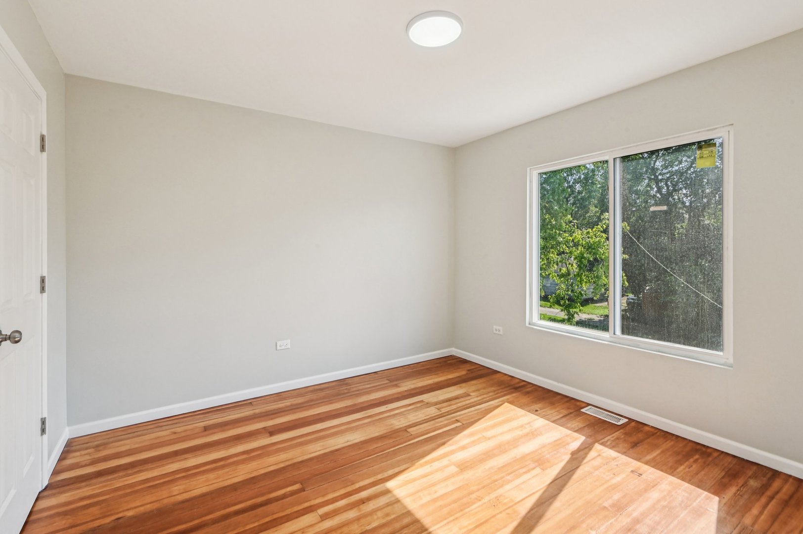 608 Whitley Avenue Joliet, IL 60433 - Photo 25 of 38 a view of empty room with wooden floor and fan