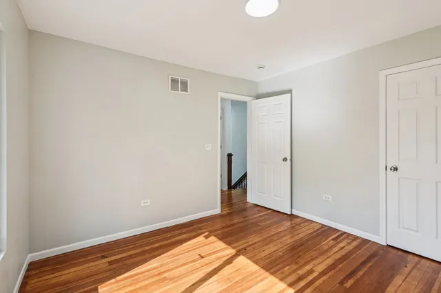a view of a room with wooden floor and closet