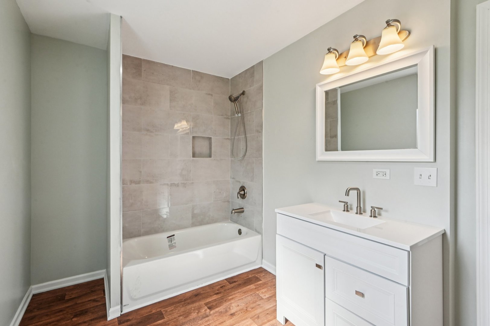 608 Whitley Avenue Joliet, IL 60433 - Photo 30 of 38 a bathroom with a sink a bathtub a mirror a vanity and a shower