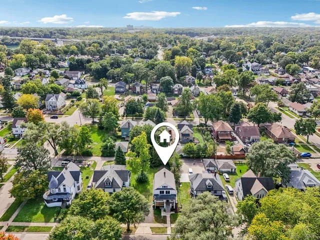 an aerial view of residential houses with outdoor space and street view