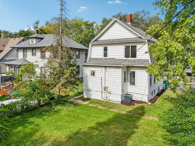 a front view of a house with a garden and plants
