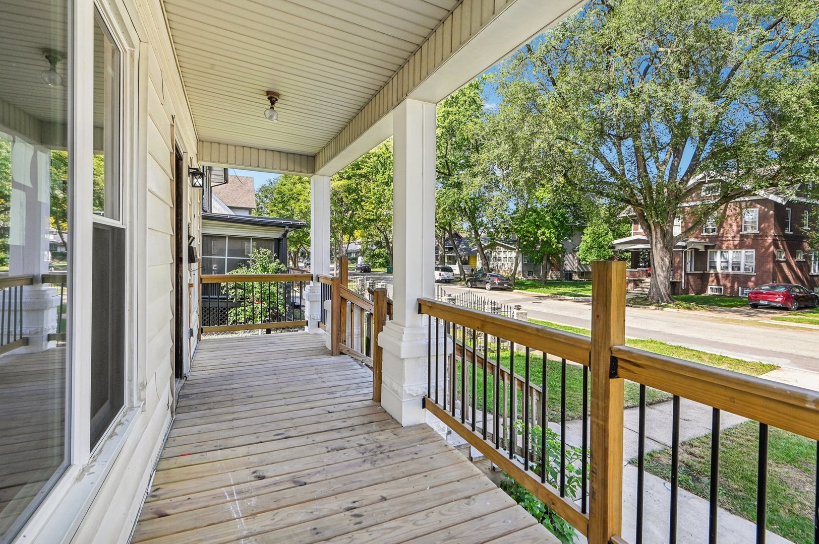608 Whitley Avenue Joliet, IL 60433 - Photo 4 of 38 a view of a porch with wooden floor and wooden fence