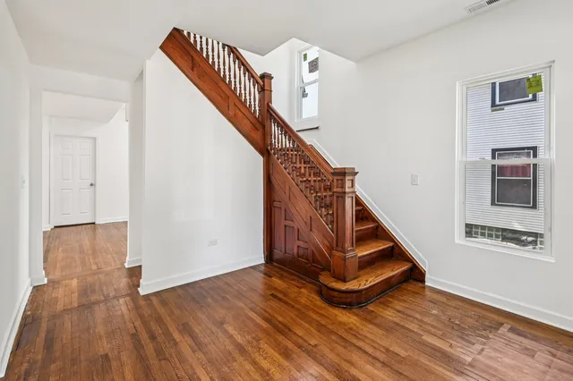 a view of an entryway with wooden floor