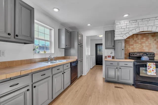 a kitchen with stainless steel appliances kitchen island granite countertop a sink counter space cabinets and appliances