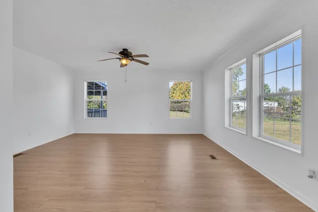 wooden floor in an empty room with a window