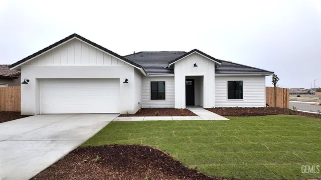 a front view of house with yard and garage