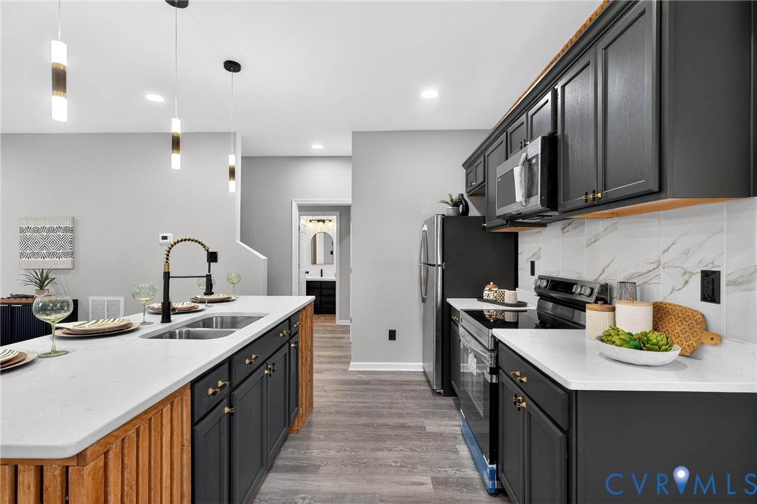 1952 Powell Road Richmond, VA 23224 - Photo 12 of 36 a kitchen with stainless steel appliances granite countertop a sink stove and cabinets