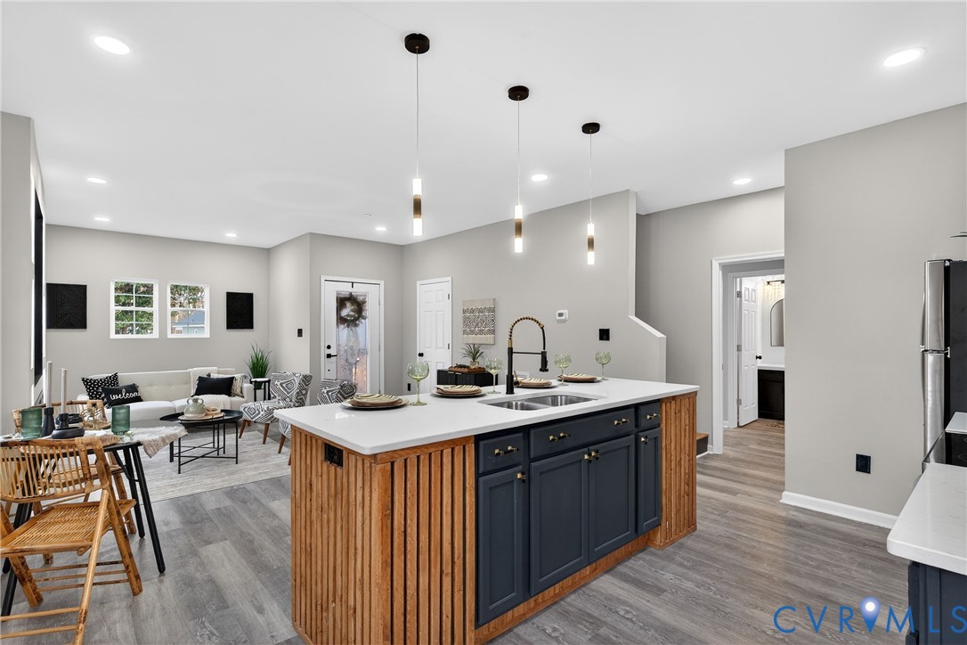 1952 Powell Road Richmond, VA 23224 - Photo 14 of 36 a large kitchen with stainless steel appliances lots of counter space and wooden floor