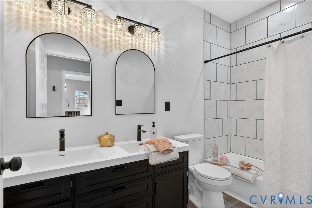 1952 Powell Road Richmond, VA 23224 - Photo 18 of 36 a bathroom with a granite countertop sink mirror and toilet