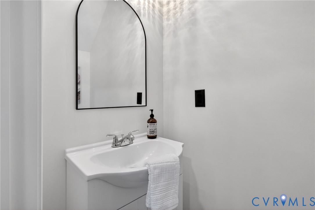 1952 Powell Road Richmond, VA 23224 - Photo 21 of 36 a bathroom with a sink and a mirror
