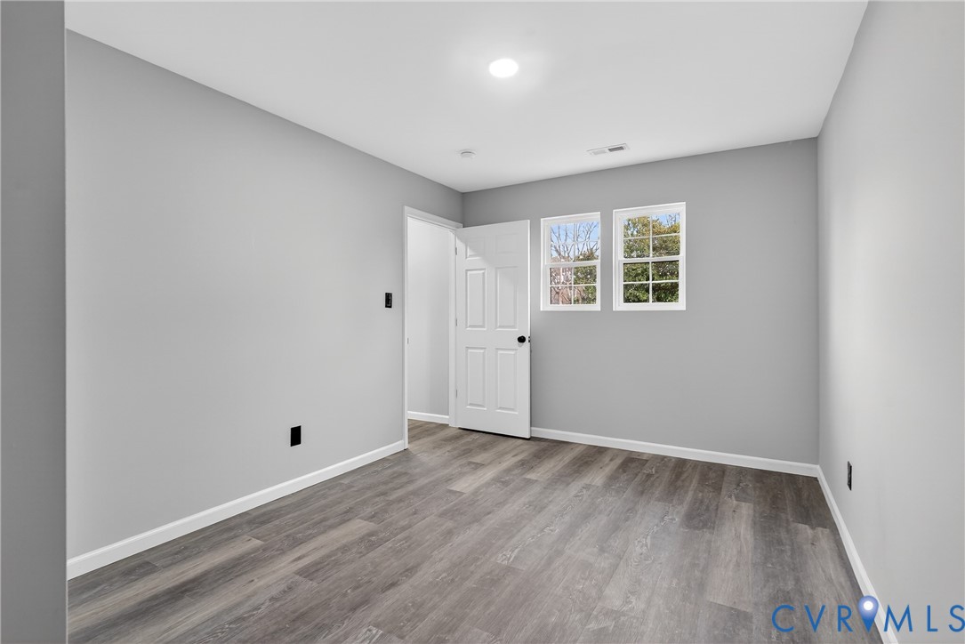 1952 Powell Road Richmond, VA 23224 - Photo 31 of 36 an empty room with wooden floor and windows